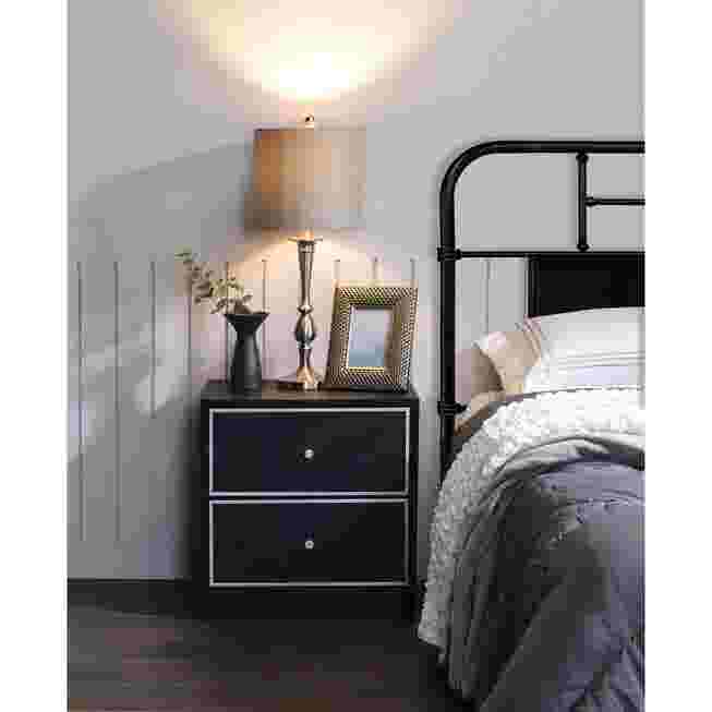 Black accent table in a bedroom
