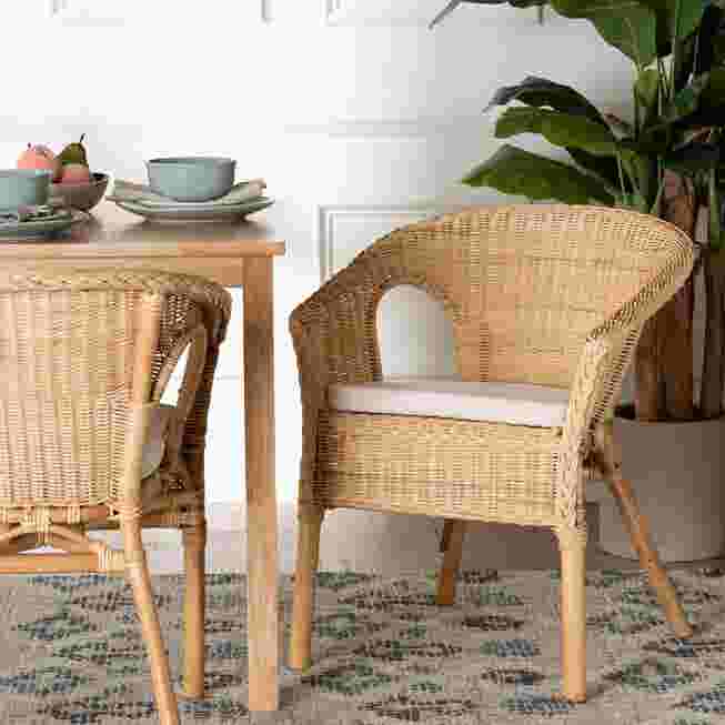 Natural rattan dining chair with white cushioned seat