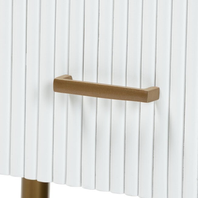 Close-up of gold bar pull on white fluted dresser