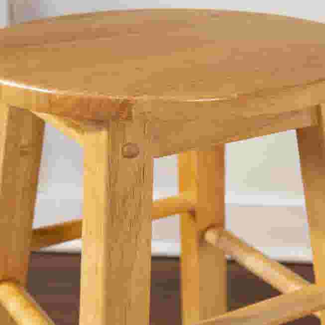 Close-up of wood bar stool frame and side ladder support