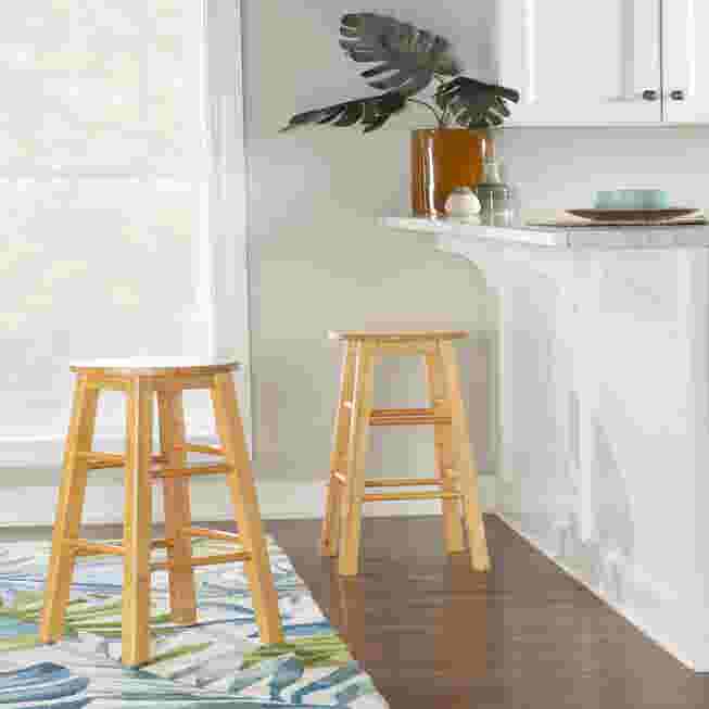 Natural wood bar stool with round seat in kitchen setting