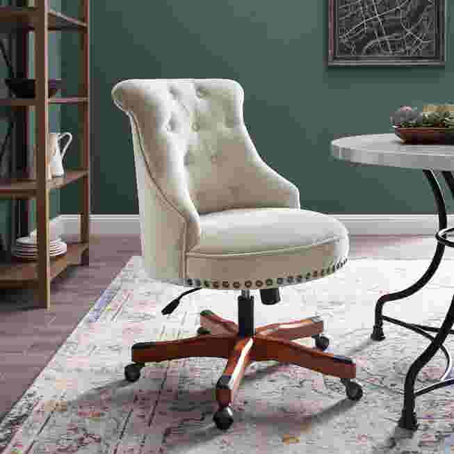 Cream/white tufted chair in room setting