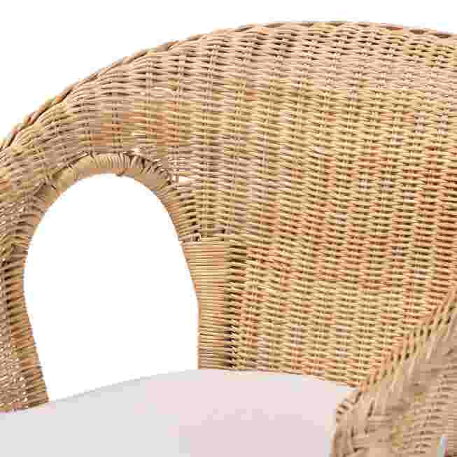 Close-up of natural rattan chair back and white seat cushion
