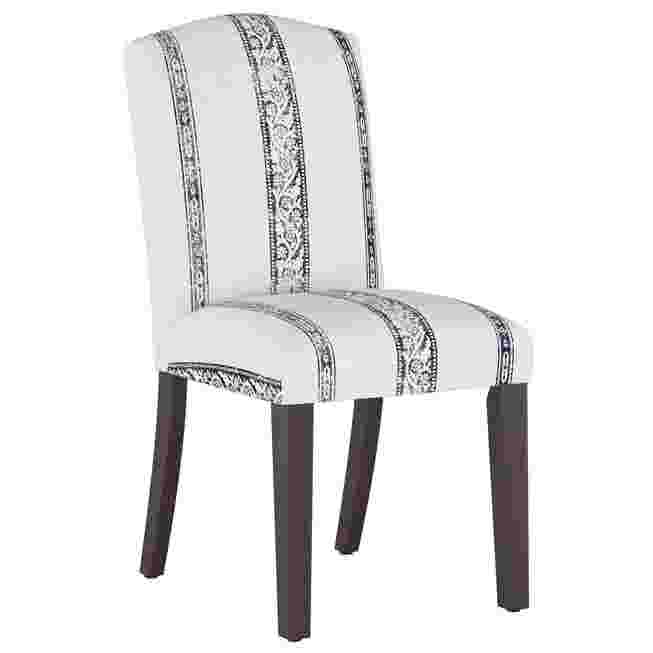 White dining chair with patterned upholstery and dark wooden legs