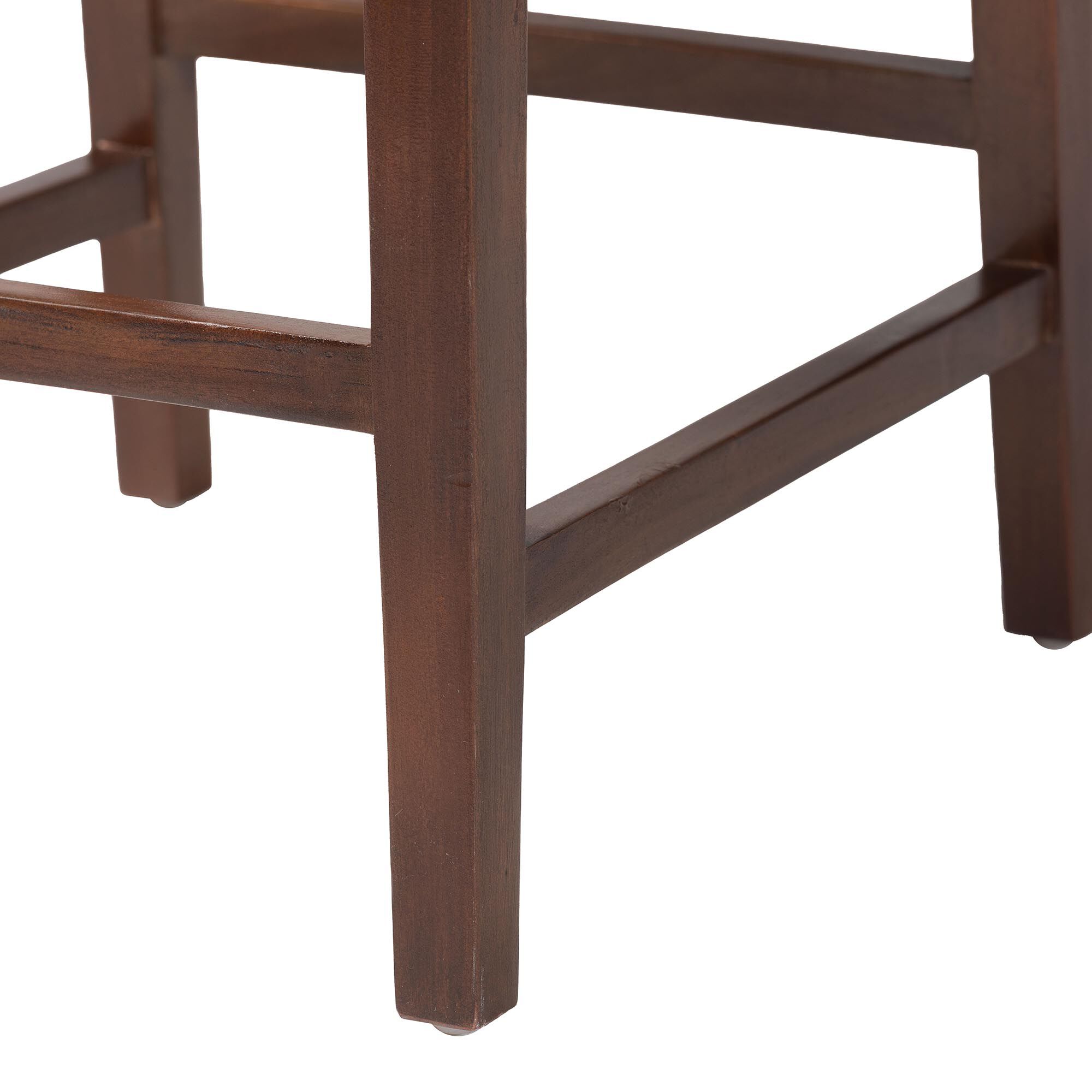 Close-up of dark wooden legs and footrest on seagrass bar stool
