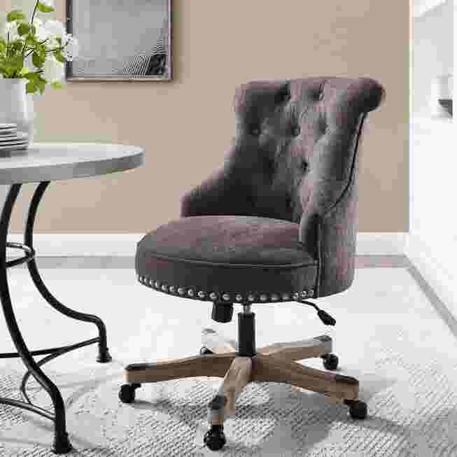 Grey tufted office chair in a room setting