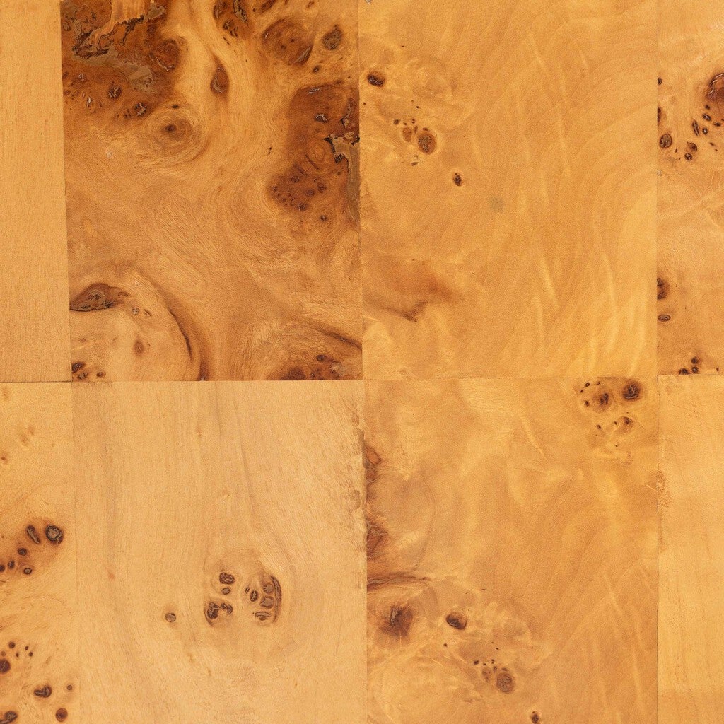 Close-up of burl wood veneer showing natural knots and swirling grain patterns.
