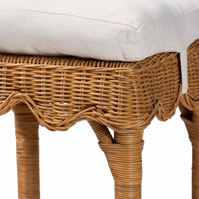 Close-up of scalloped honey rattan weave and upholstered seat edge