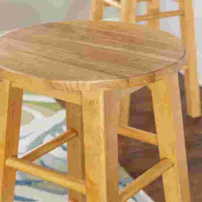 Close-up of natural wood bar stool seat and ladder frame