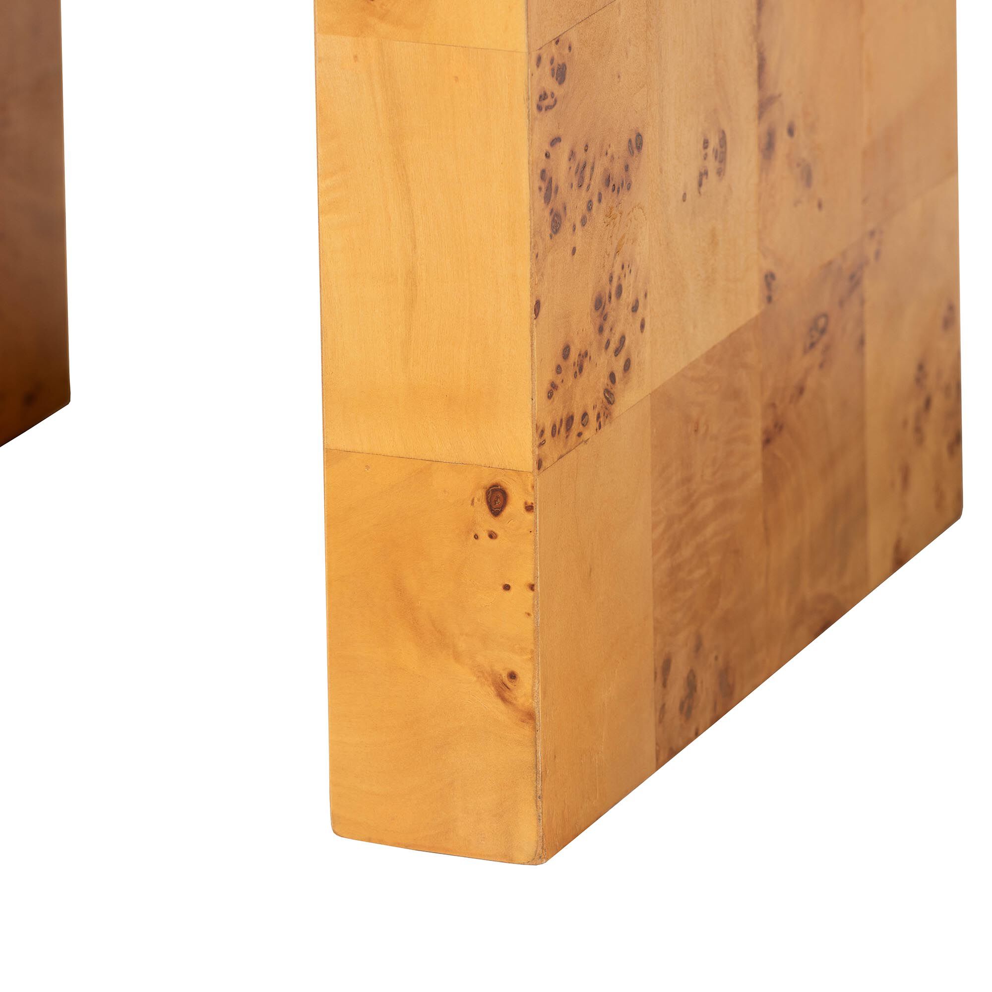 One leg and lower edge of the end table with visible grain and imperfections in the wood.